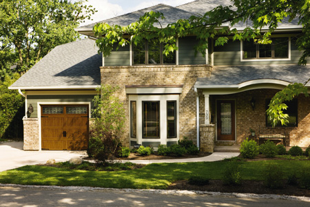 Clopay carriage house style wood garage door on a brick home
