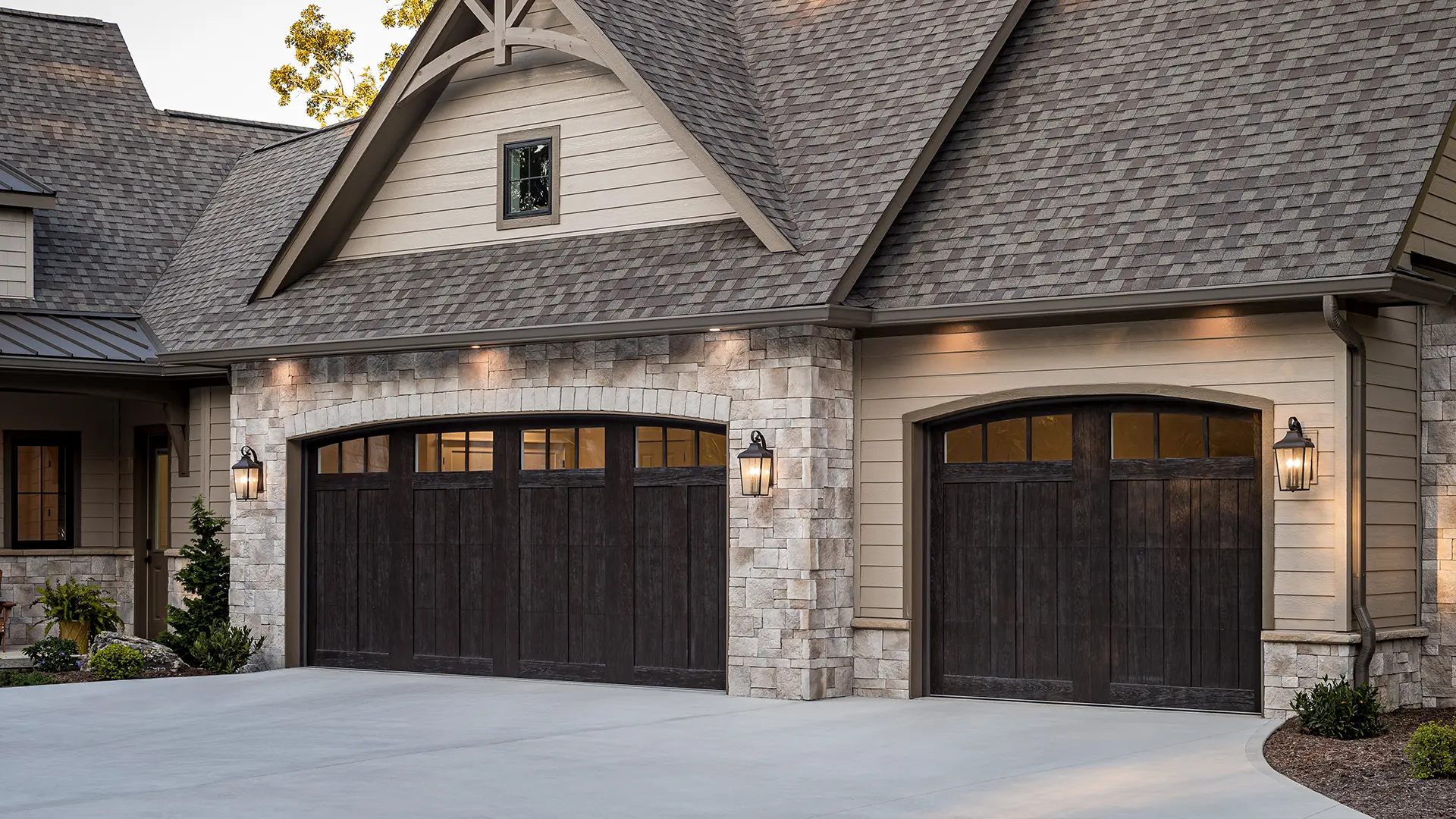 Canyon Ridge® 5-Layer garage door in Design 11 with ARCH13A windows in Espresso Finish