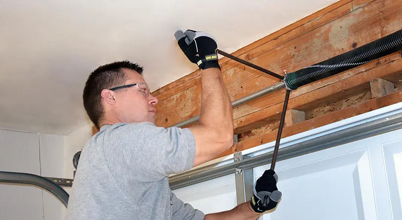 Man winding a torsion spring