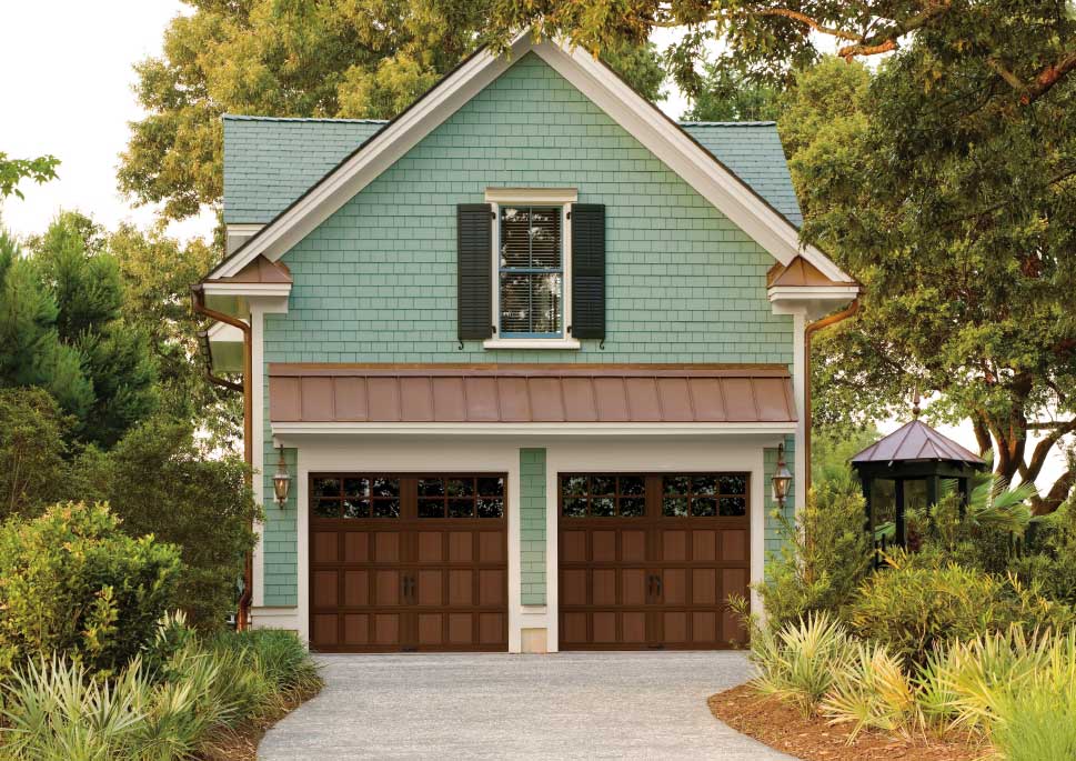 Natural wood garage doors with windows on victorian style home
