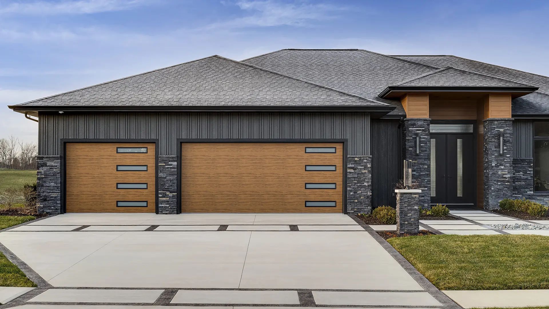 Modern Steel™ garage door with flush panels and contemporary slim black windows in Ultra-Grain® Medium Finish