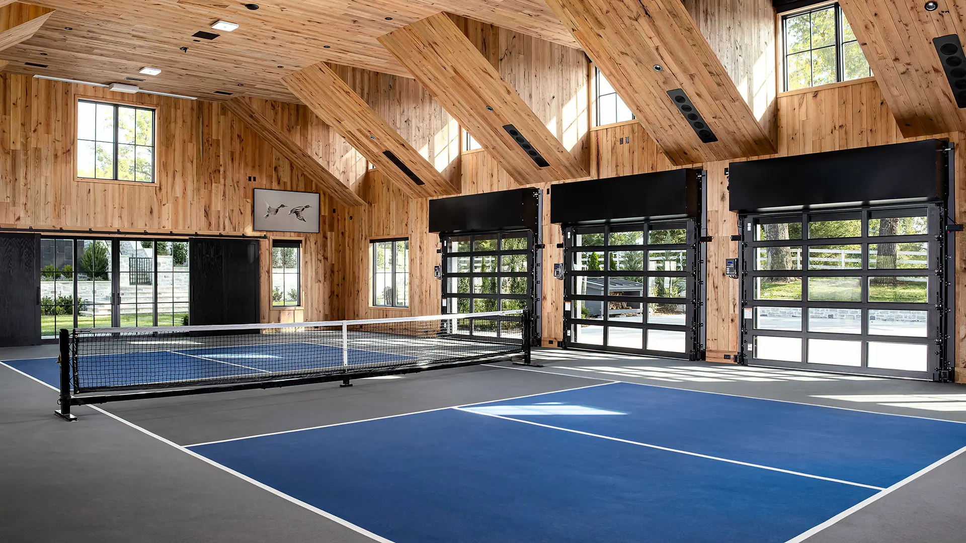 VertiStack® Avante® garage door with black anodized frame and clear glass