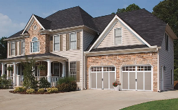 Grand Harbor Garage Doors | Design 12 with SQ24 Windows in Sandtone Finish with White Overlay