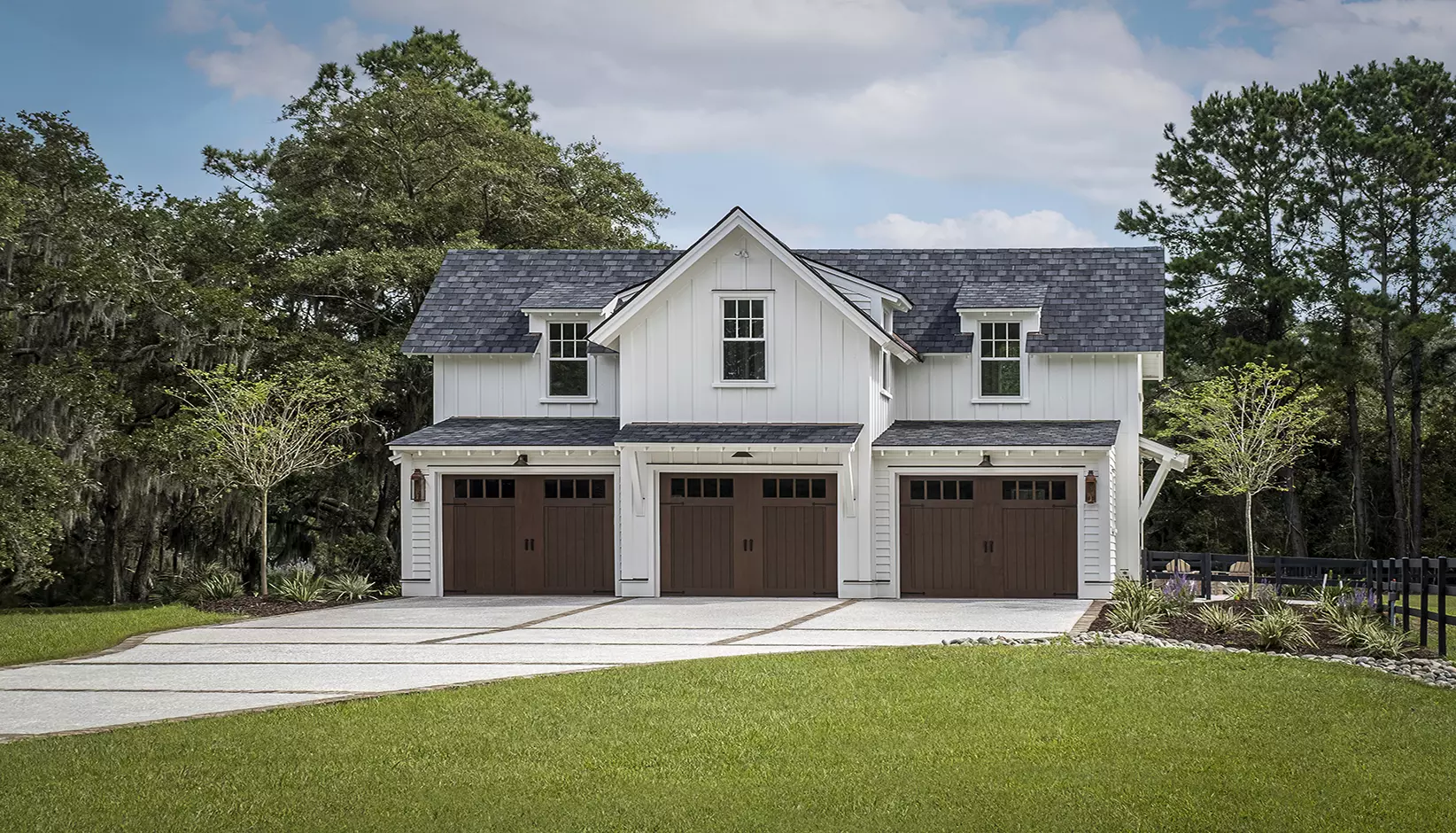 Canyon Ridge 5-Layer garage door in Design 11 with REC14 windows in Walnut Finish